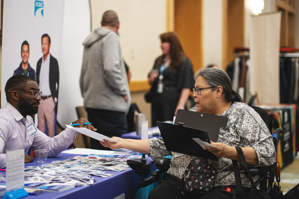 Indigenous woman in a wheelchair attending a trade show supported by the New Relationship Trust’s Indigenous Labour Market Fund.